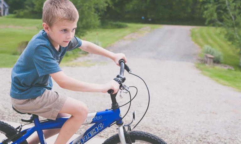 Canva - Boy Rides Blue Trek Bike at Daytime